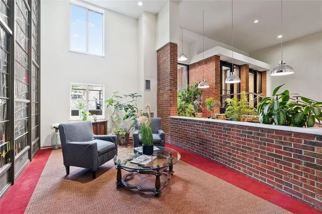 a outdoor living space with furniture potted plant and a window