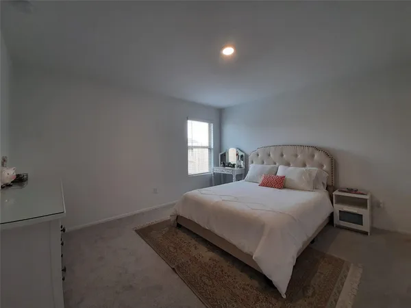 a bedroom with a bed and window