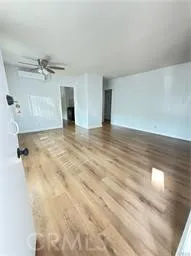 a view of an empty room with a ceiling fan