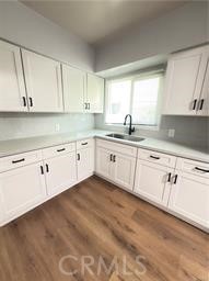 7457 Mt Vernon Street, Unit A Riverside, CA 92504 - Photo 3 of 8 a kitchen with white cabinets sink and window