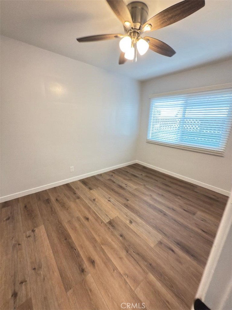 7457 Mt Vernon Street, Unit A Riverside, CA 92504 - Photo 6 of 7 wooden floor in an empty room with a window
