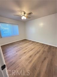 7457 Mt Vernon Street, Unit A Riverside, CA 92504 - Photo 6 of 8 a view of an empty room with wooden floor and chandelier