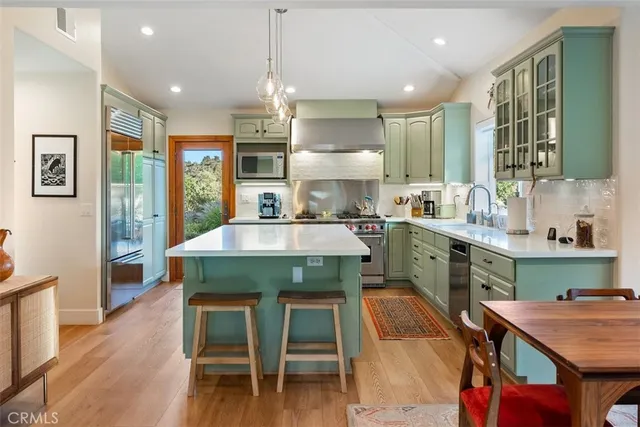 a kitchen with cabinets a sink and appliances