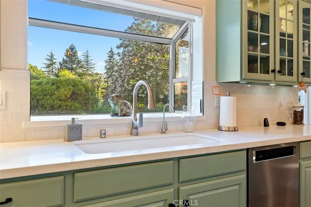 a utility room with wooden floor washer and dryer