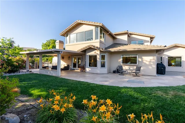 a view of a house with a yard and sitting area