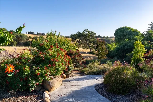 a view of a backyard with sitting area and garden