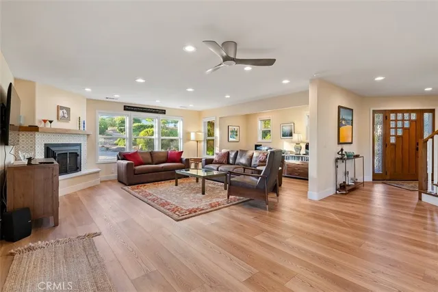 a living room with furniture a flat screen tv and a fireplace