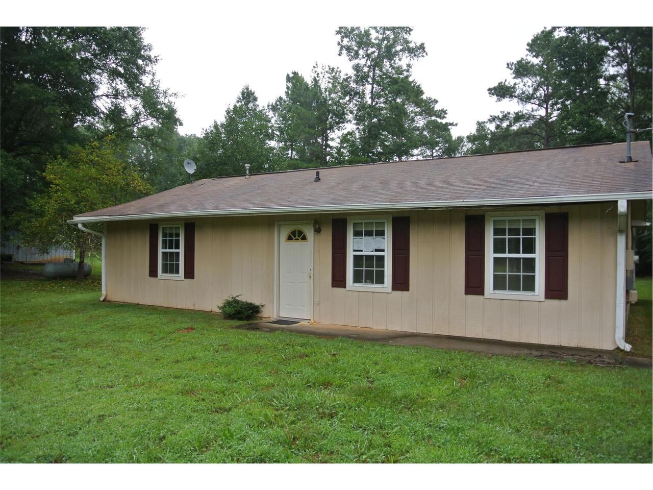 115 J J Smith Road Newnan, GA 30263 - Photo 1 of 1 a view of a yard in front of a house with plants and large tree