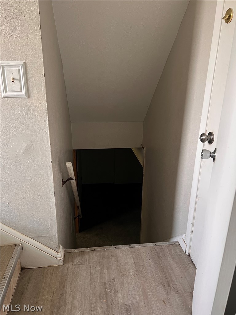 16350 Rockside Road Maple Heights, OH 44137 - Photo 28 of 34 Entryway featuring wood-finish flooring, a white interior door with a silver-toned knob, and a light switch with a decorative frame