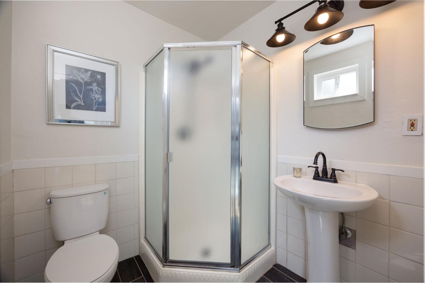 1572 Linda Mar Boulevard Pacifica, CA 94044 - Photo 18 of 25 a bathroom with a toilet sink and mirror