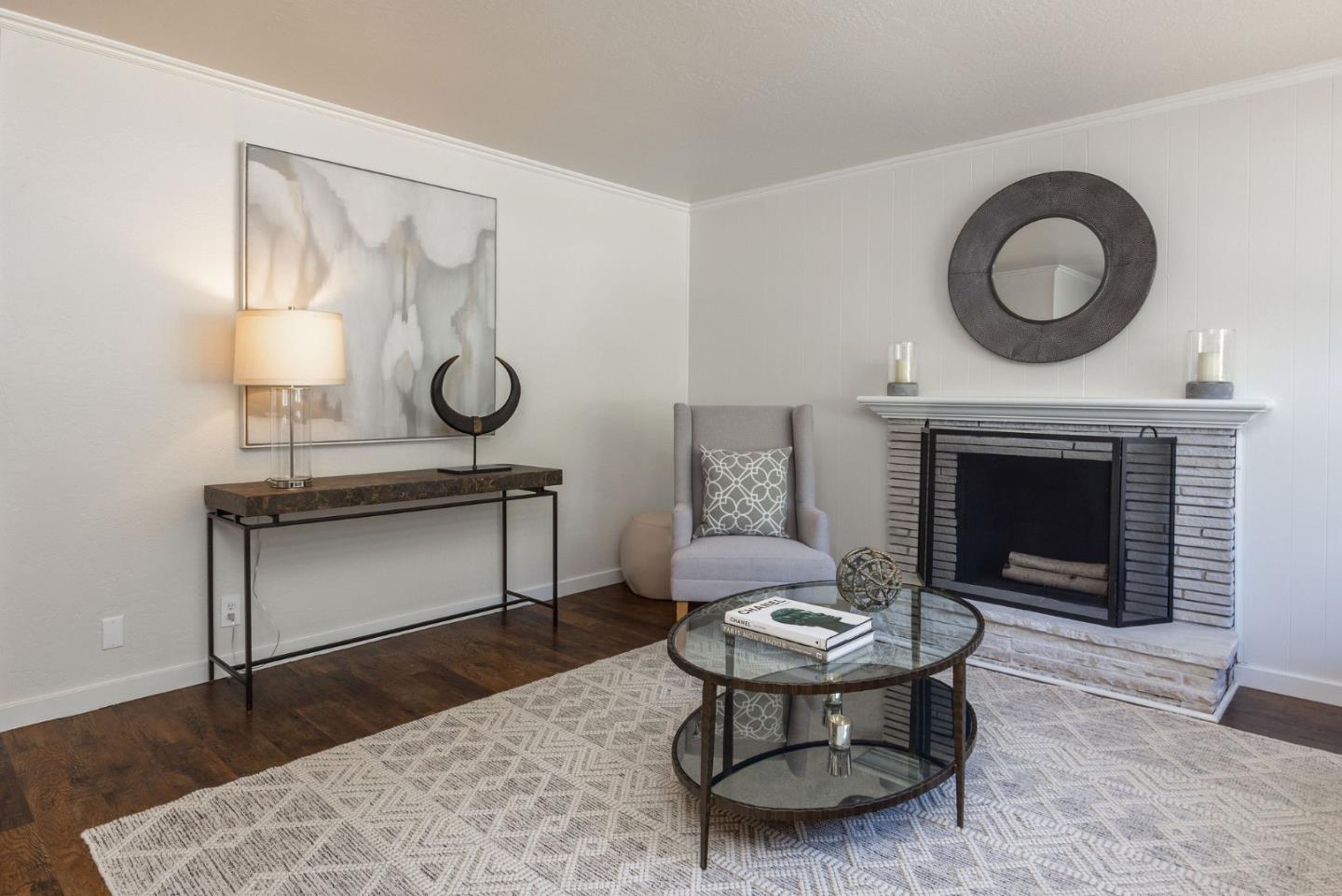 1572 Linda Mar Boulevard Pacifica, CA 94044 - Photo 3 of 25 a living room with furniture a clock and a fireplace
