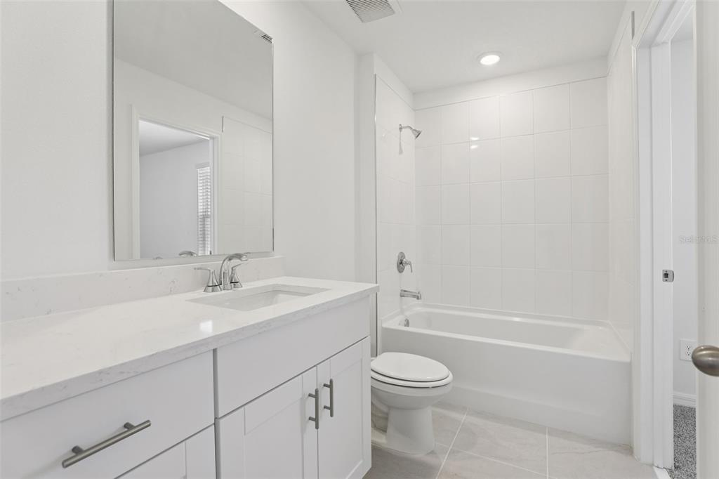 4264 Ranch House Road St. Cloud, FL 34772 - Photo 64 of 74 a bathroom with a sink a toilet and shower