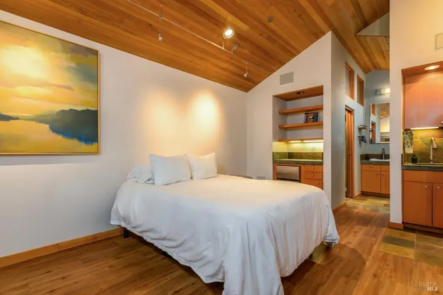 a bathroom with a granite countertop sink a mirror and shower