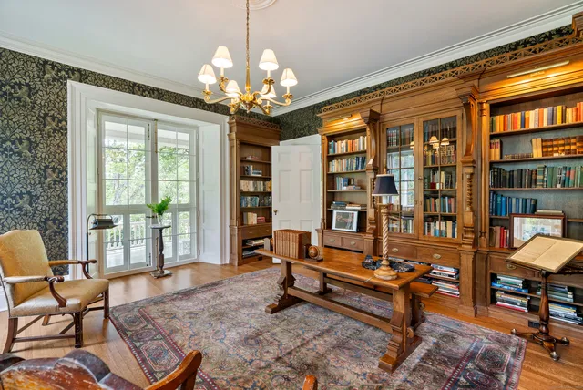 a living room with furniture a chandelier and fireplace