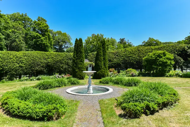 a large kitchen with granite countertop a sink and a refrigerator