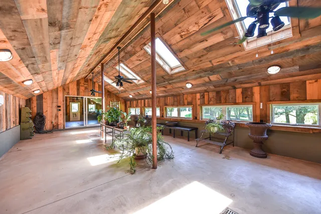 a view of a backyard with plants and patio