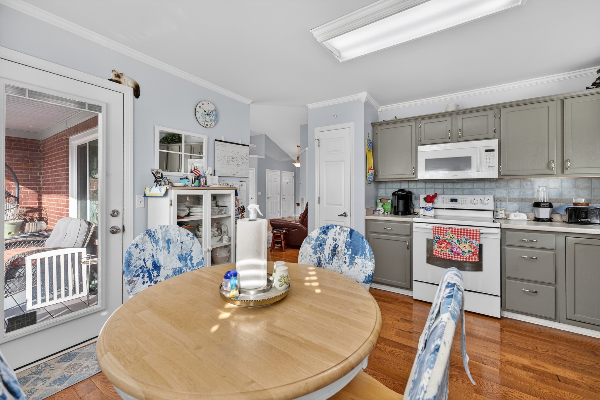 5444 Reagan Run Antioch, TN 37013 - Photo 16 of 46 a kitchen with stainless steel appliances kitchen island granite countertop a dining table chairs and view of living room