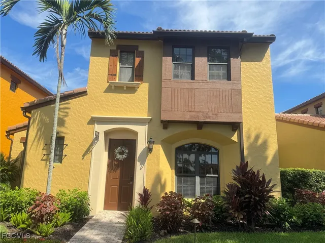 a front view of a house with plants and garden