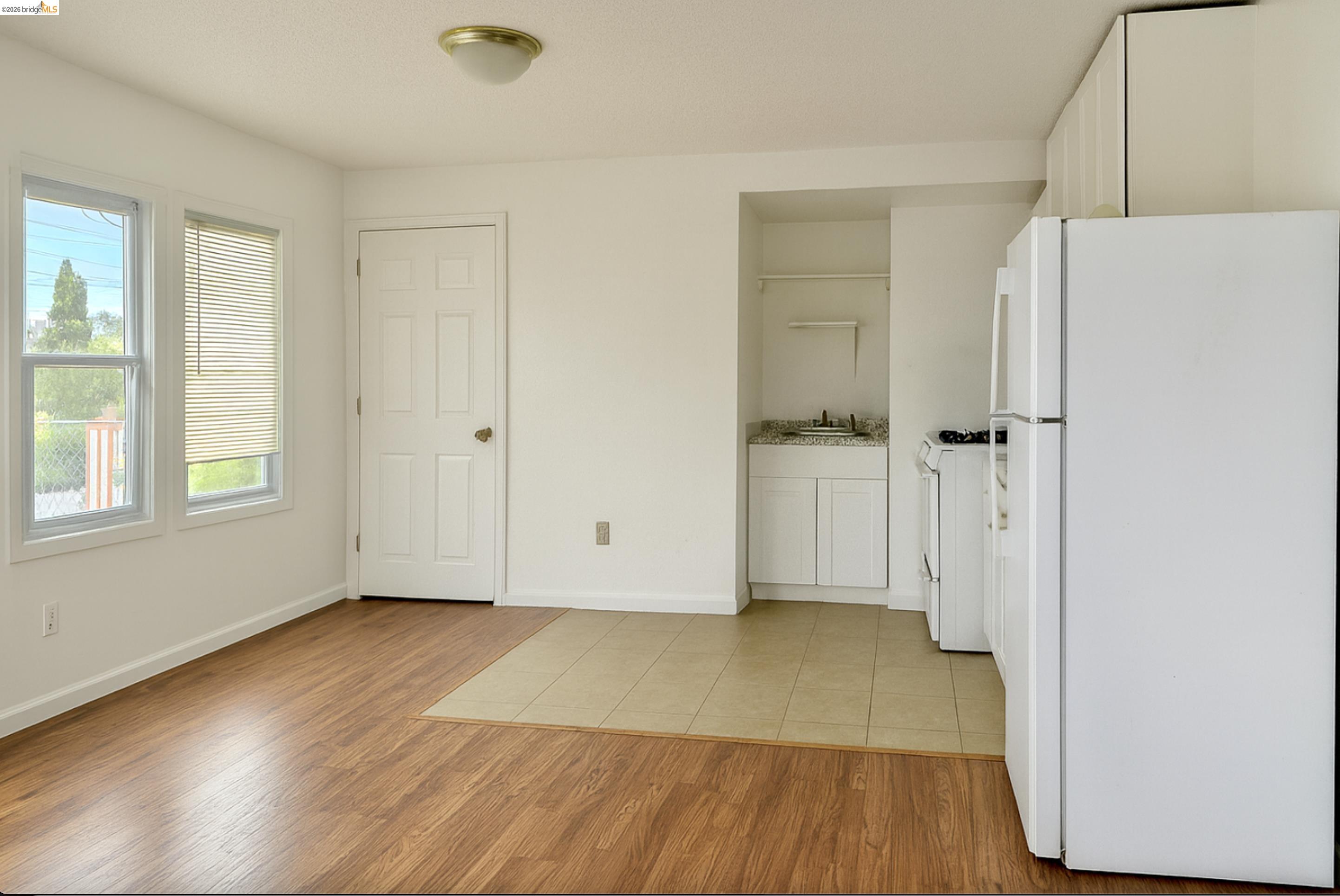 121 Lincoln Road East Vallejo, CA 94590 - Photo 10 of 15 Kitchen with white appliances, light wood finished floors, white cabinetry, and light countertops