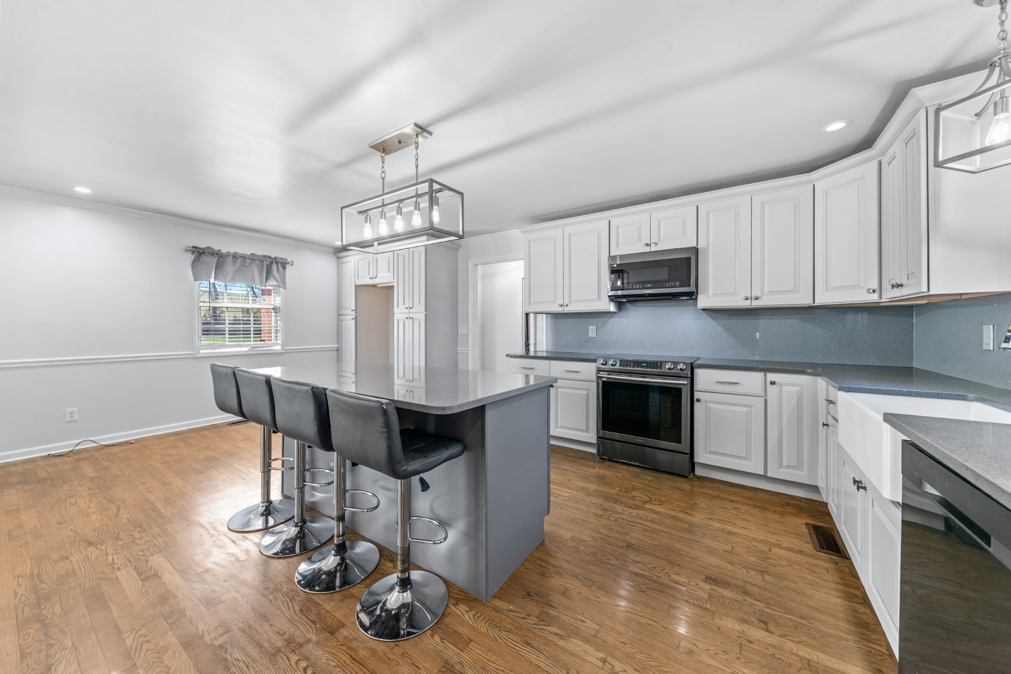 2200 Crescentview Road Pulaski, TN 38478 - Photo 12 of 69 a kitchen with granite countertop a stove top oven a sink dishwasher a dining table and chairs with wooden floor