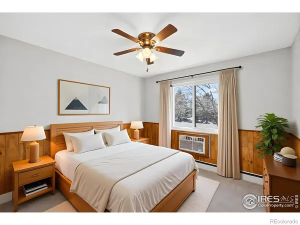 a bedroom with a balcony a bed and a chandelier