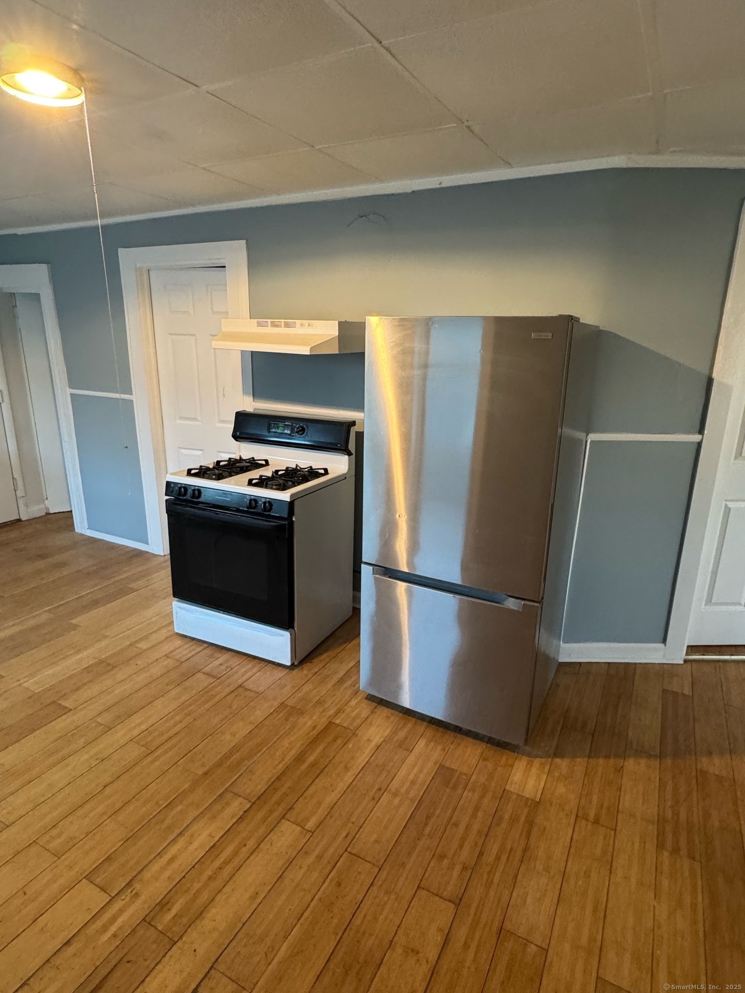 95 Center Street, Unit 1 Bridgeport, CT 06604 - Photo 2 of 4 a kitchen with a refrigerator and a stove