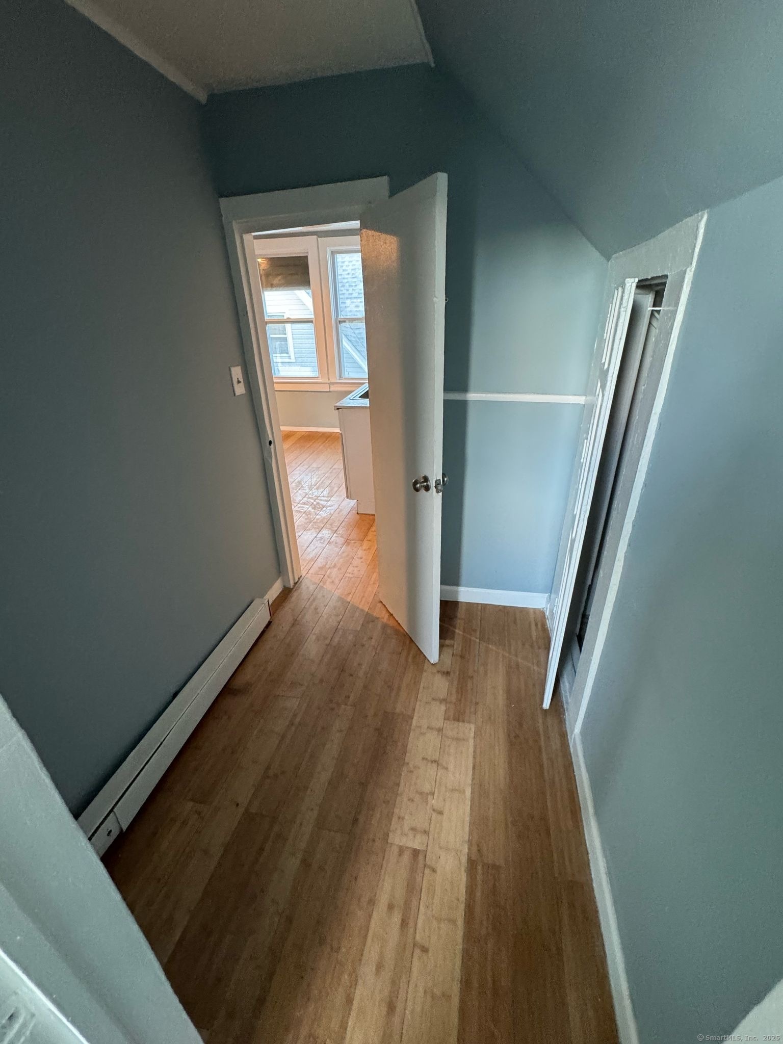 95 Center Street, Unit 1 Bridgeport, CT 06604 - Photo 3 of 4 a view of hallway with wooden floor and stairs