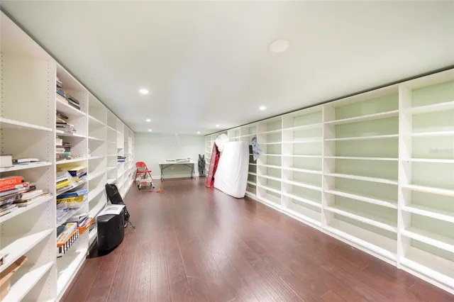 a view of a room with lots of wooden furniture and window