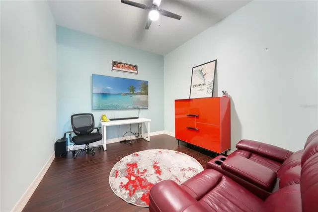 a view of a hallway with wooden floor and furniture