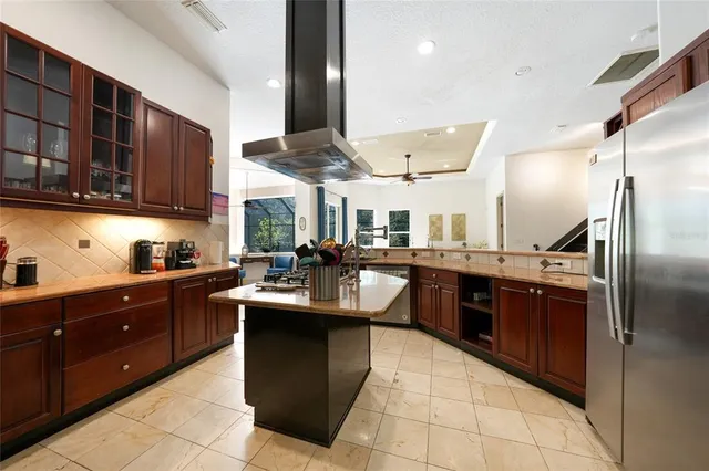 a kitchen with stainless steel appliances granite countertop a sink counter space cabinets and a large window