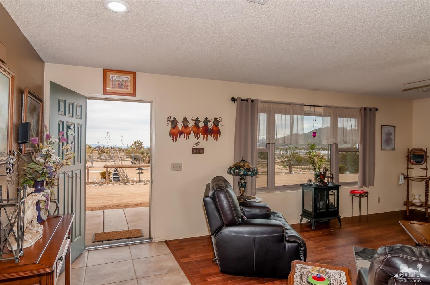 3290 Julcrest Road Yucca Valley, CA 92284 - Photo 3 of 20 a living room with furniture and a floor to ceiling window