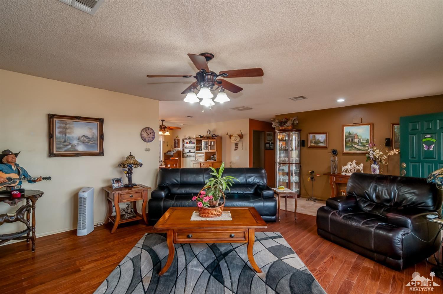 3290 Julcrest Road Yucca Valley, CA 92284 - Photo 4 of 20 a living room with furniture and a chandelier