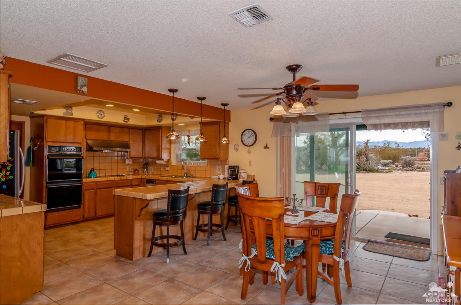 3290 Julcrest Road Yucca Valley, CA 92284 - Photo 6 of 20 a view of a dining area with furniture window and outside view