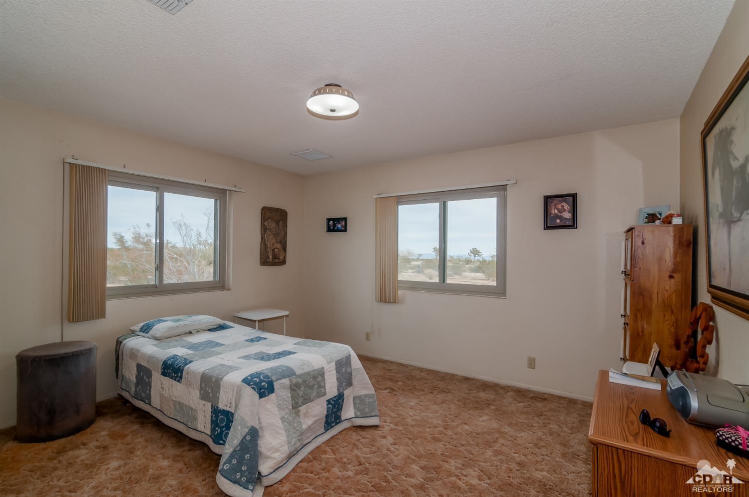 3290 Julcrest Road Yucca Valley, CA 92284 - Photo 9 of 20 a bedroom with a bed and a window