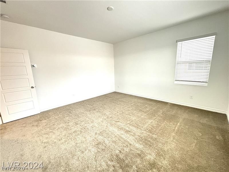 8336 Rowan Rdg Avenue Las Vegas, NV 89147 - Photo 9 of 15 This spacious room offers comfort and versatility, perfect for creating your ideal living space.