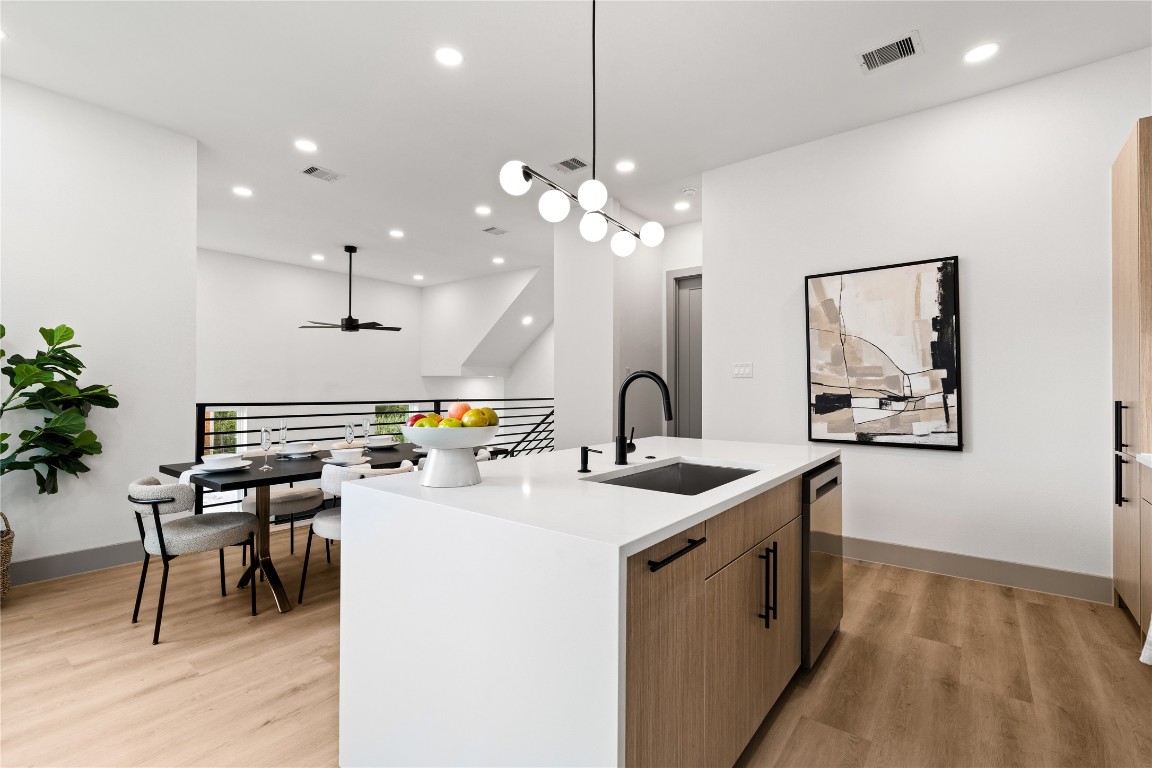 2950 Pitzlin Street Houston, TX 77023 - Photo 12 of 37 Modern minimalism meets effortless functionality—this oversized island anchors the open-concept layout with clean quartz surfaces, matte black fixtures, and built-in storage. Whether you’re prepping dinner or hosting friends, it’s the everyday centerpiece that does it all with style.