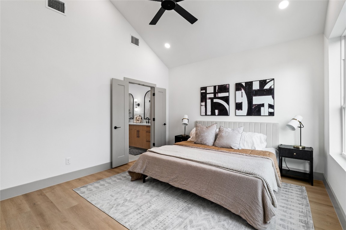 2950 Pitzlin Street Houston, TX 77023 - Photo 23 of 37 Framed by vaulted ceilings and wide-plank flooring, the primary suite flows seamlessly into a spa-inspired bath through double doors—offering both comfort and convenience in a refined, retreat-like setting. A perfect blend of privacy and polish.