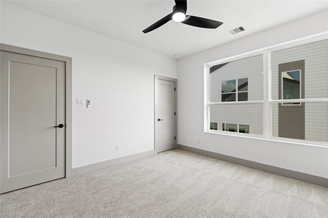 2950 Pitzlin Street Houston, TX 77023 - Photo 30 of 37 This secondary bedroom offers both comfort and versatility—featuring plush carpeting, neutral tones, generous closet space, and abundant natural light from oversized windows. A peaceful space ready to adapt to your lifestyle.