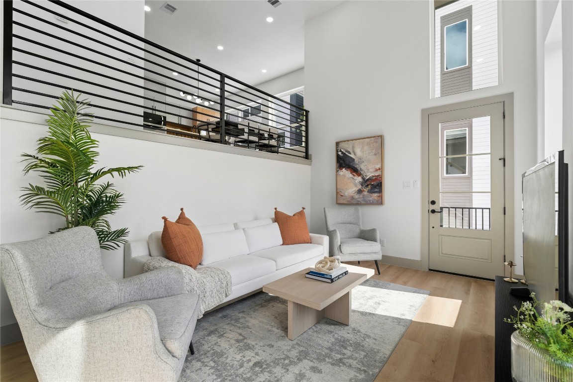 2950 Pitzlin Street Houston, TX 77023 - Photo 4 of 37 Enjoy a bright, modern living space with durable SPC flooring and a stunning visual connection to the dining area above—bringing style and function together across split levels.