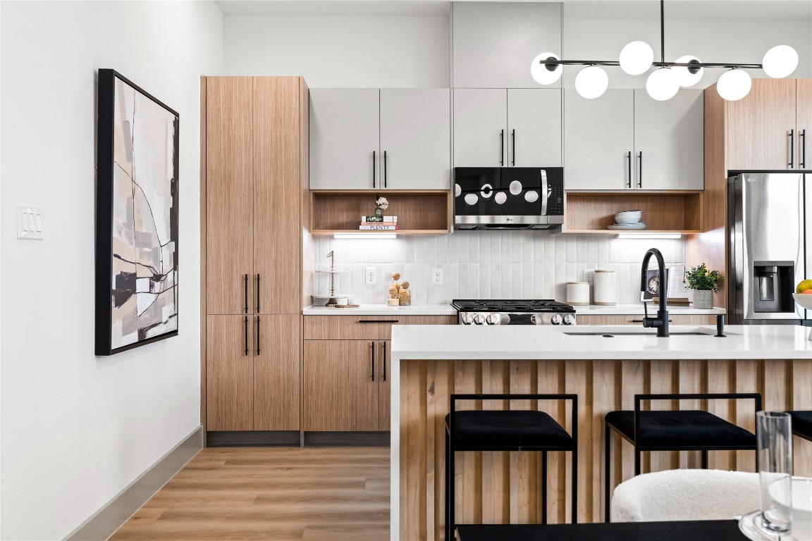 2950 Pitzlin Street Houston, TX 77023 - Photo 10 of 37 Even from the corner, this kitchen tells a story of modern ease—clean lines, natural wood tones, and light-filled windows create a calming atmosphere you’ll love coming home to.