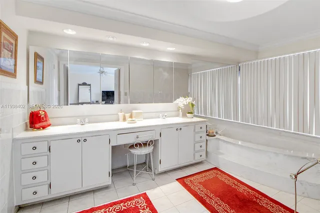a bathroom with a sink vanity and mirror