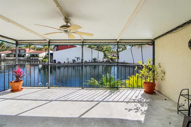 a view of a porch with wooden floor and furniture