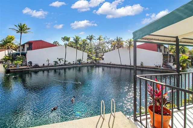 a swimming pool with trees in front of it