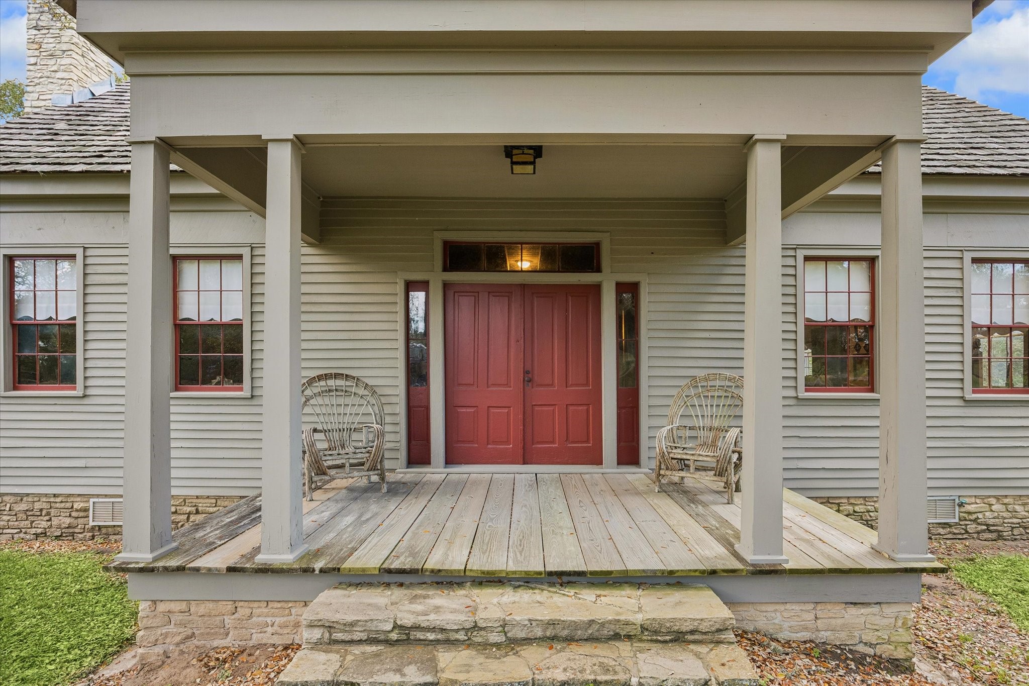 207 Bauer Rummel Round Top, TX 78954 - Photo 4 of 21 Welcoming front porch with double front doors and stone skirting around the house.