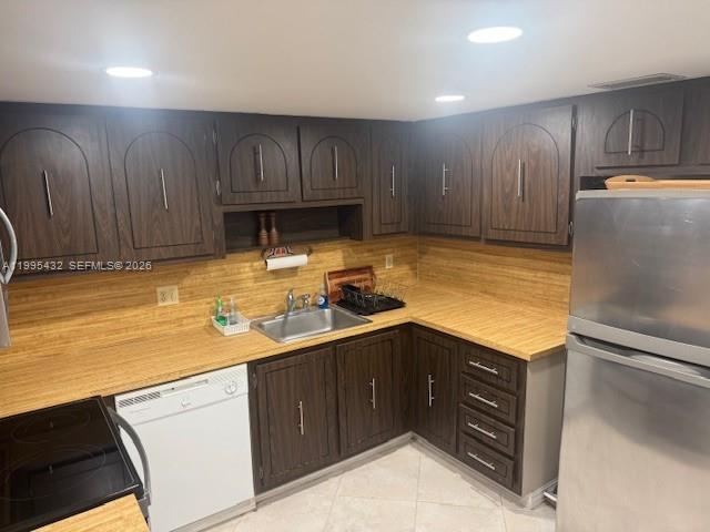 16300 Golf Club Road, Unit 208 Weston, FL 33326 - Photo 9 of 24 a kitchen with a sink appliances and cabinets