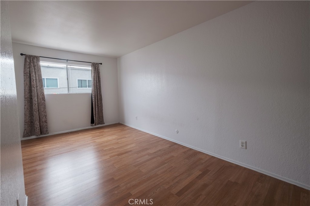 3771 Harvill Lane Riverside, CA 92503 - Photo 33 of 53 a view of an empty room with wooden floor and a window