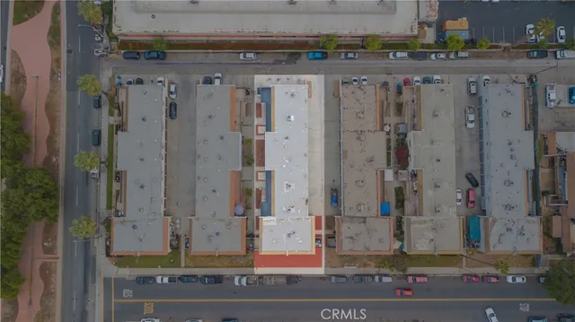 an aerial view of a house with outdoor seating