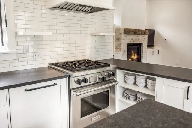 a kitchen with granite countertop a stove and a sink