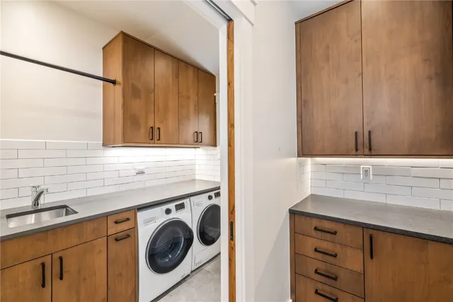 a utility room with sink dryer and washer