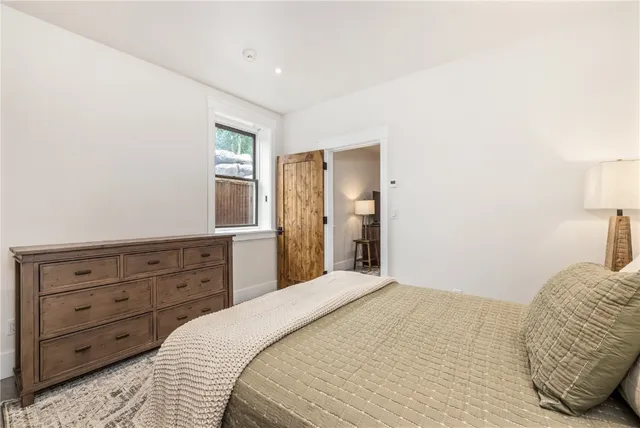 a bedroom with a bed and a dresser